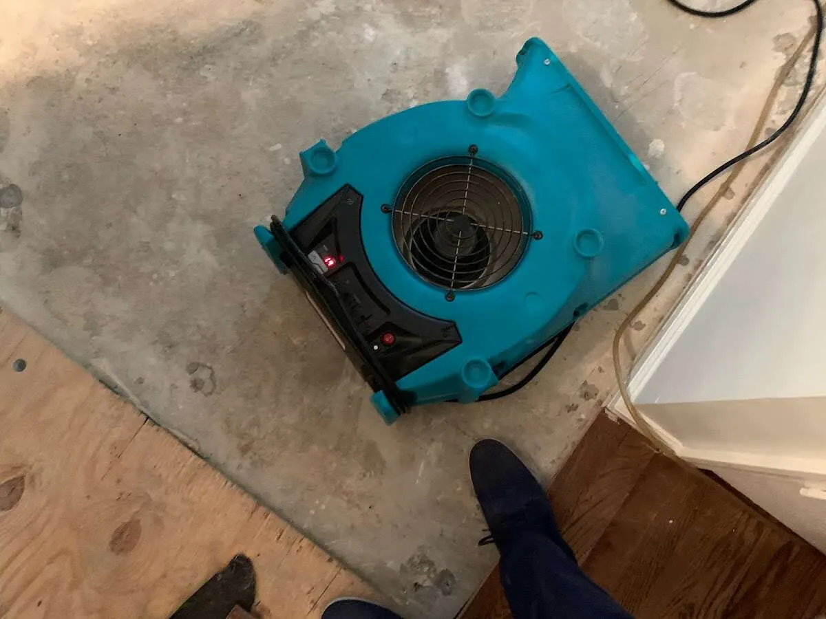 Air mover drying subfloor during Leak Detection & Repair in Pratt